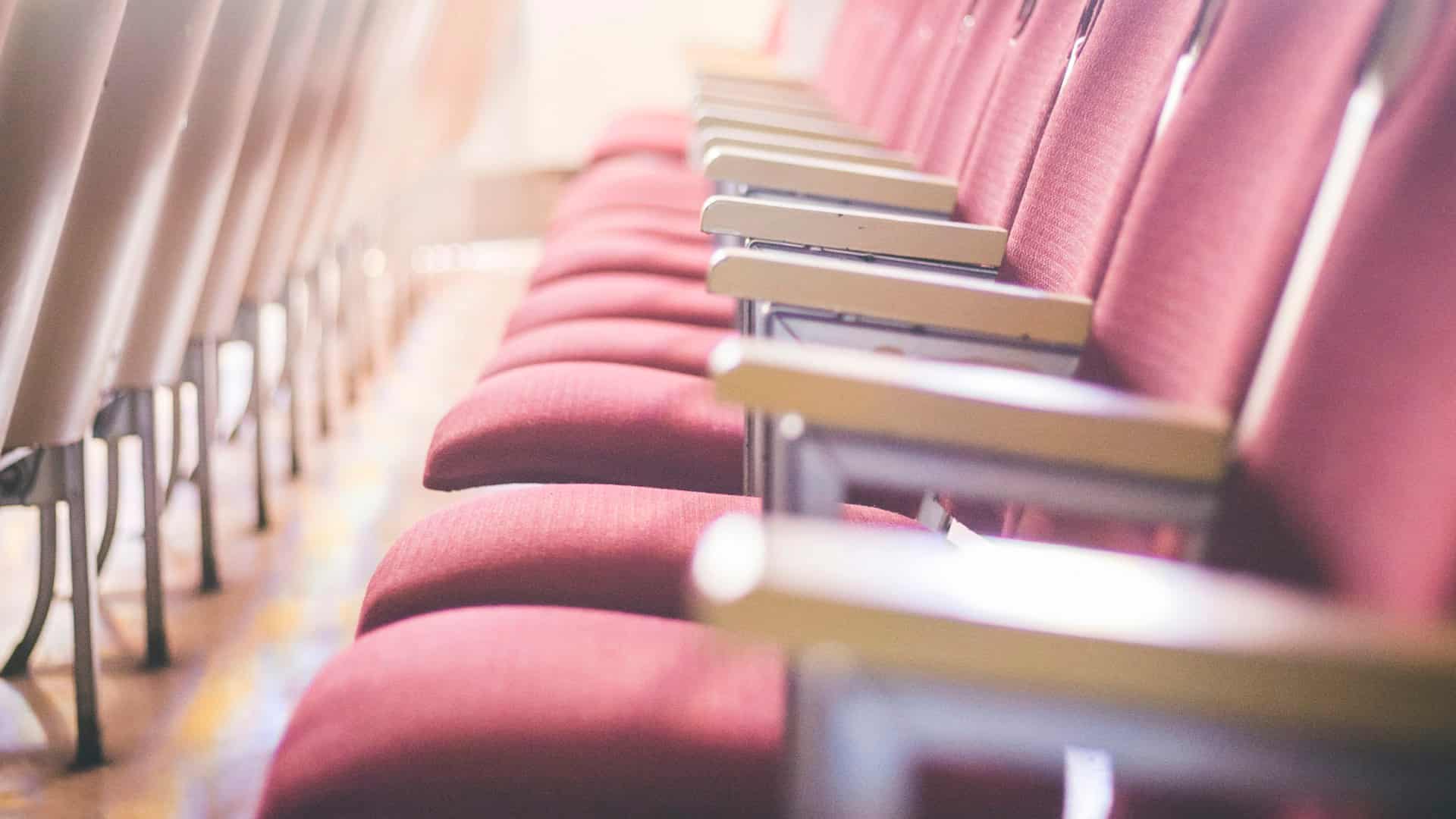 A row of empty seats in warm light