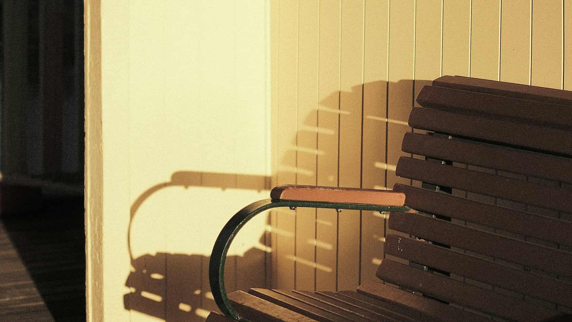 A wooden bench in warm light, off to one side