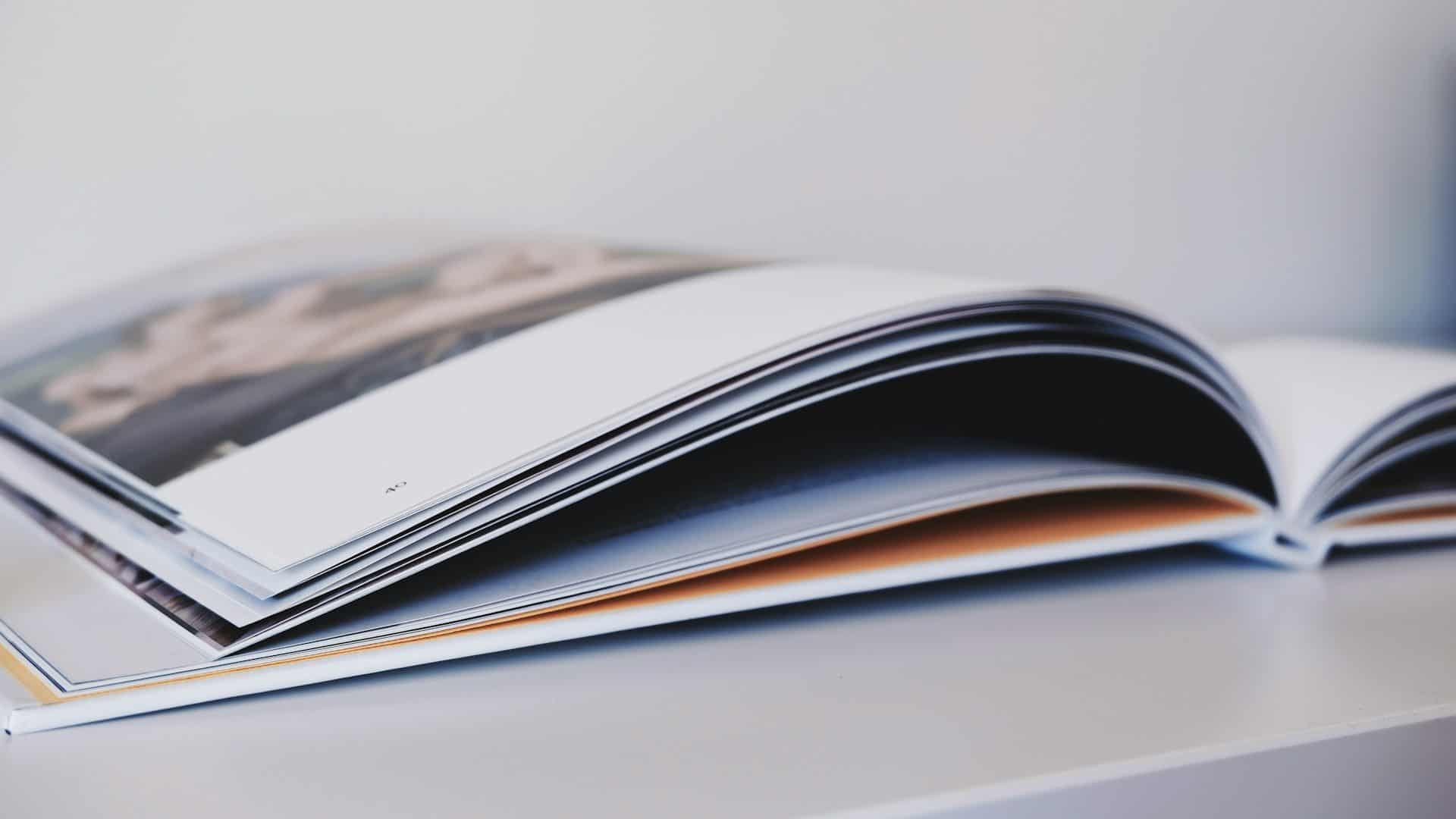 An open album, its pages fanning out on a pale table